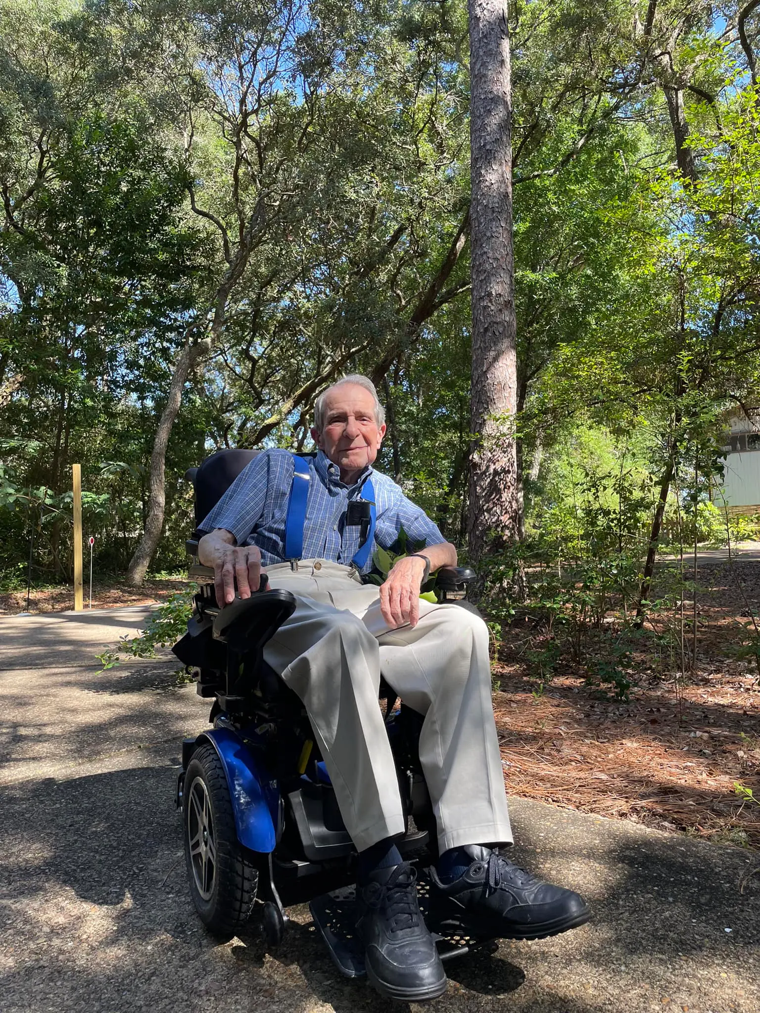 Male client in scooter smiling happily