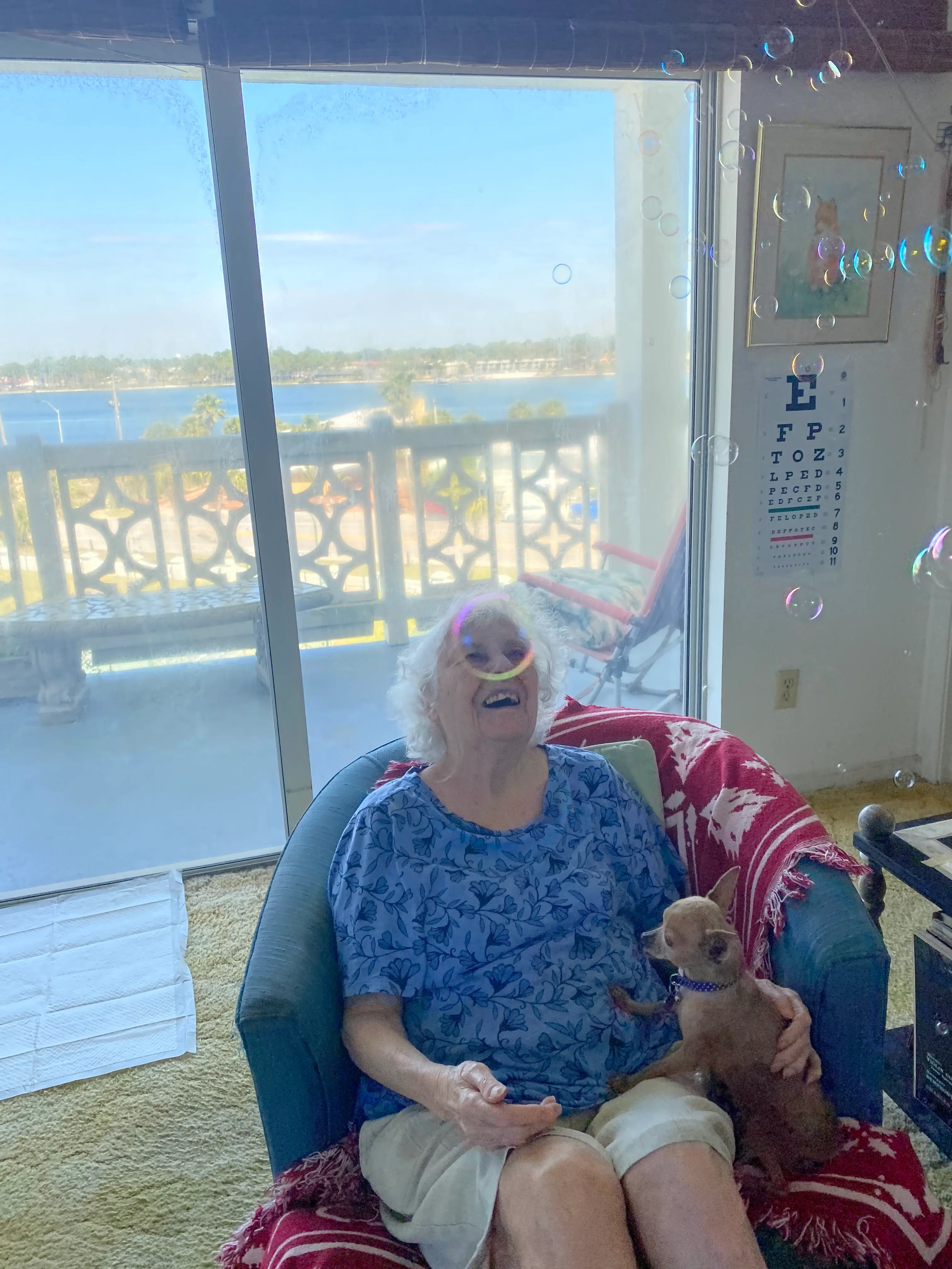Female client sitting down laughing at bubbles in the air